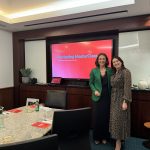 Marketing Masterclass at Servcorp with Ultimate Edge Communications Founder & CEO, Aleisha McCall, stands in front of a projector with an event attendee